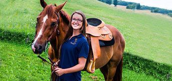 image of student with saddled horse