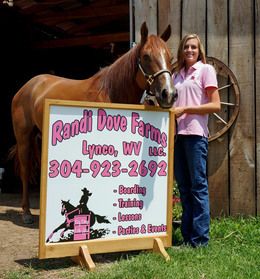 image of Randi and horse in front of her Randi Dove Farms sign that is advertising boardings, training, lessons and parties & events